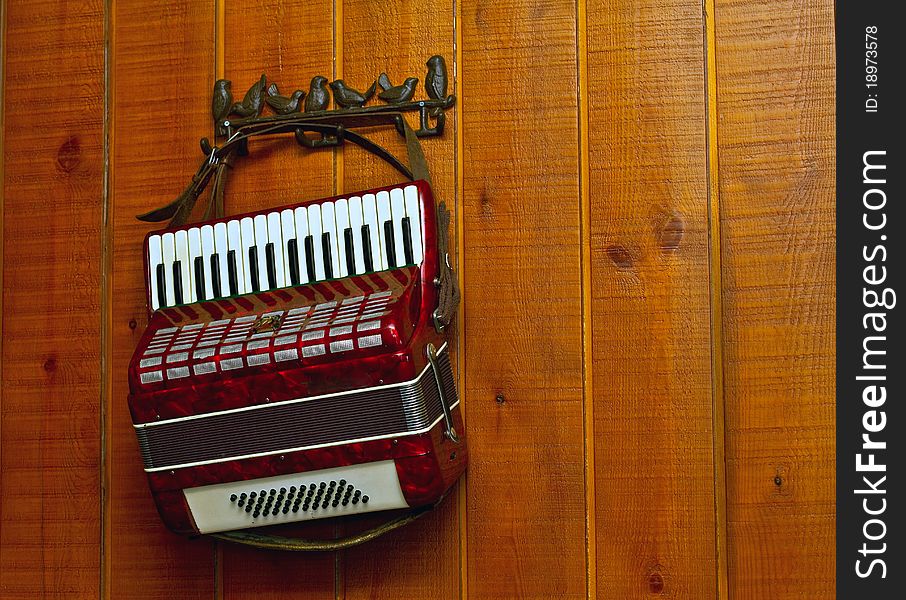 Decorative accordion on an old wooden wall. Decorative accordion on an old wooden wall