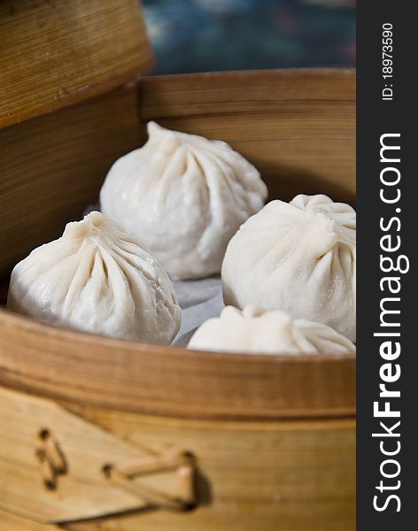 Steamed dumplings in traditional wooden steamer