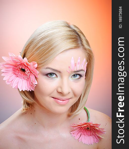 Close-up of woman green eye. Pink flower on background. Close-up of woman green eye. Pink flower on background.