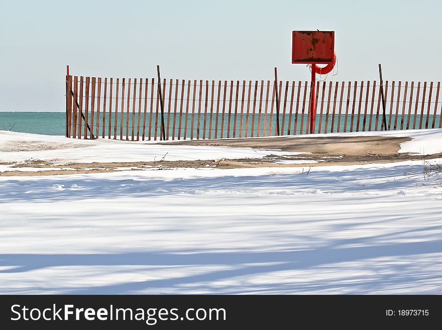 Life rescue station and snow fence in winter