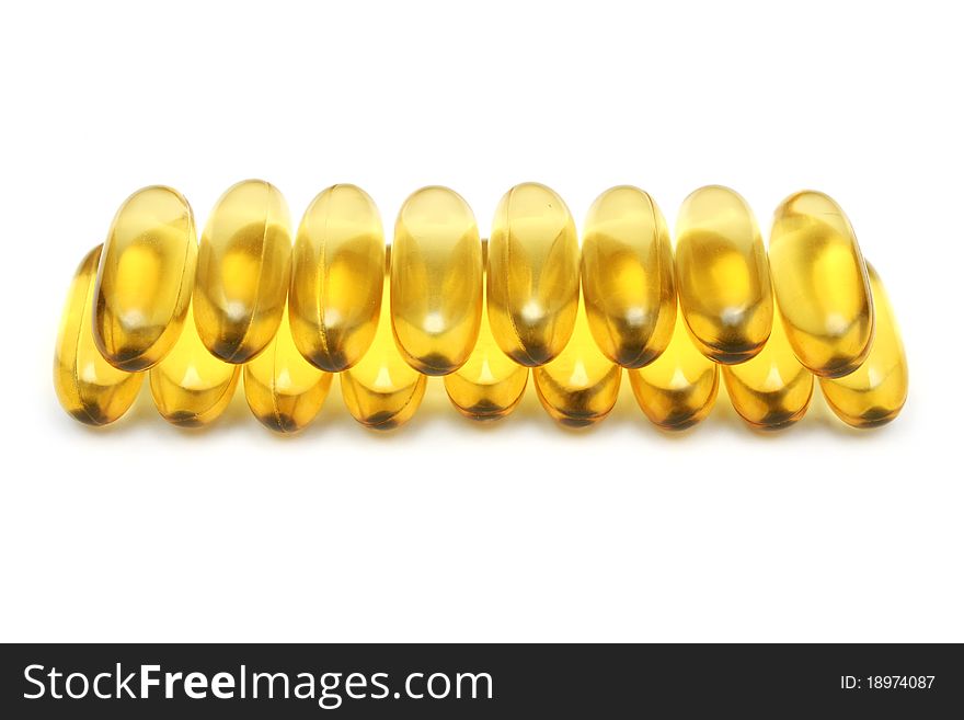 Capsules stacked in row isolated on white background.