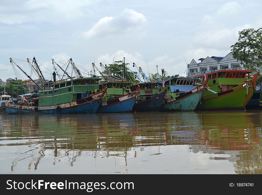 Rows of fishing boats in the river town Kuching Sarawak.