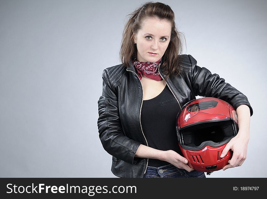 Caucasian attractive person posing with red helmet for motorsports. Caucasian attractive person posing with red helmet for motorsports