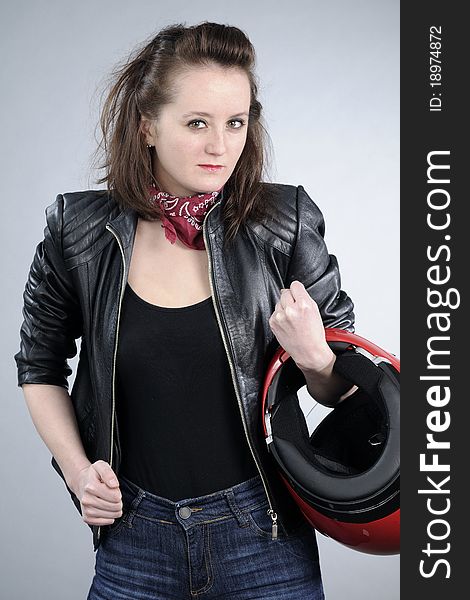 Caucasian attractive person posing with red helmet for motorsports. Caucasian attractive person posing with red helmet for motorsports