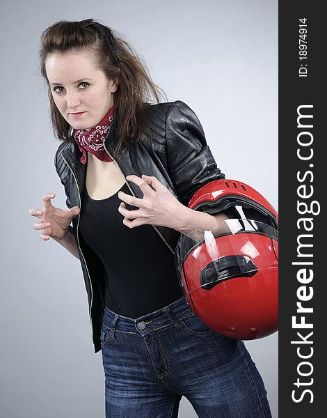 Caucasian attractive person posing with red helmet for motorsports. Caucasian attractive person posing with red helmet for motorsports