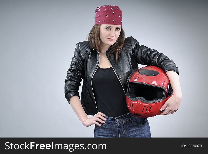 Young white biker posing with black jacket and accessories. Young white biker posing with black jacket and accessories