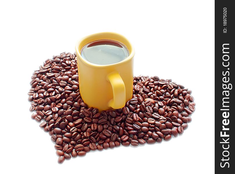 Isolated photo of coffee beans stacked in a heart-shaped and yellow ceramic mug. Isolated photo of coffee beans stacked in a heart-shaped and yellow ceramic mug