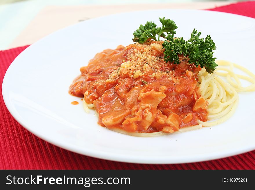 Spaghetti in tomato sauce with meats and cheese.