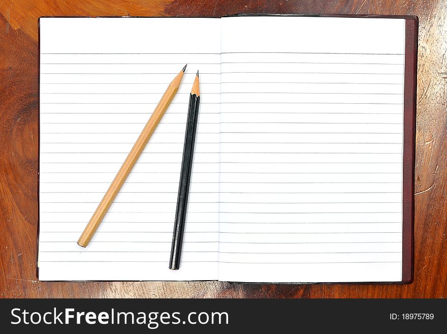 Blank open notebook and pencil