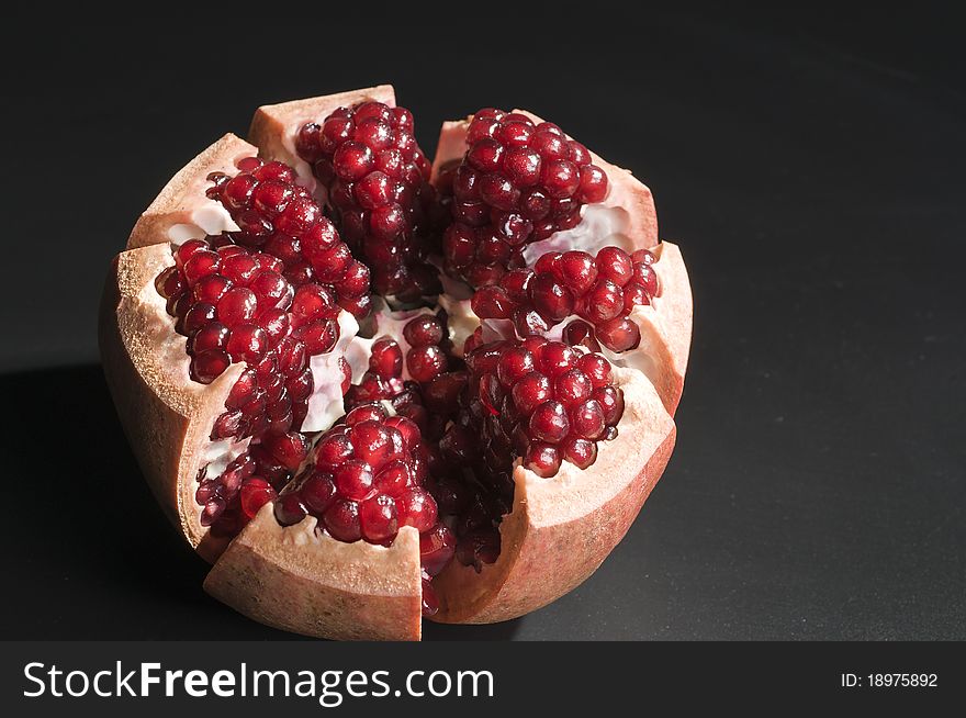 Pomegranate isolated on black background