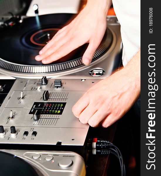 DJ's hand spinning vinyl record