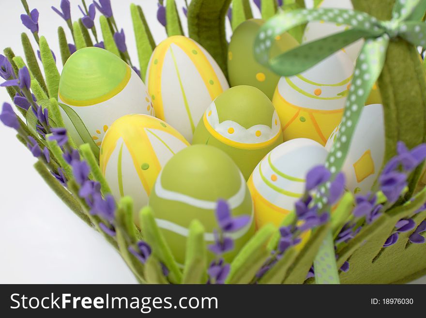 Multi-coloured eggs in a basket from a fabric from colour. Multi-coloured eggs in a basket from a fabric from colour