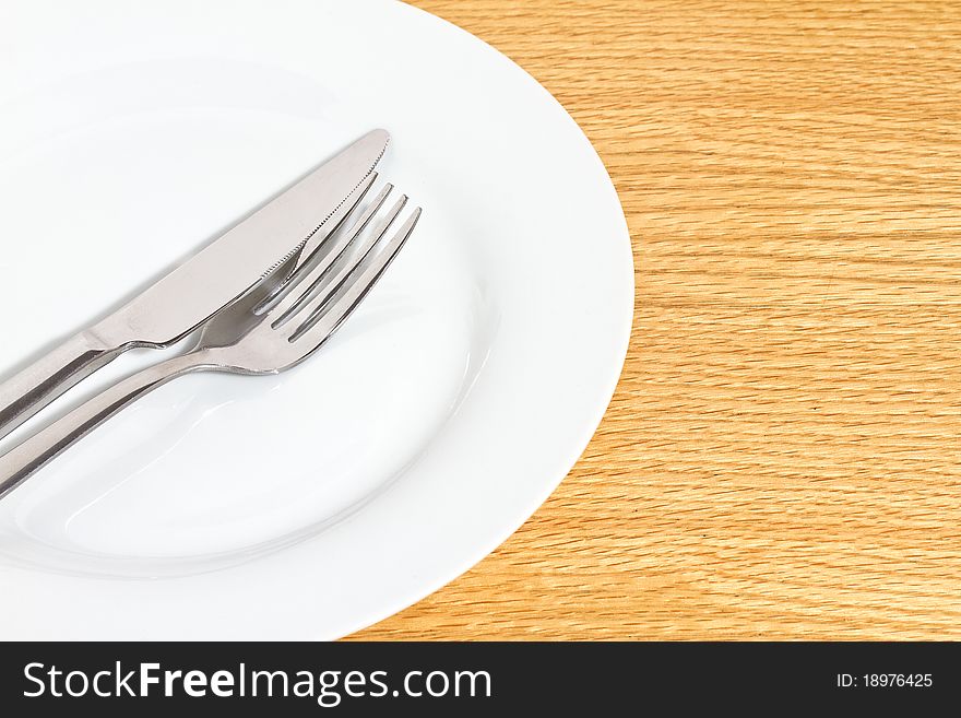 Knife and fork on white plate