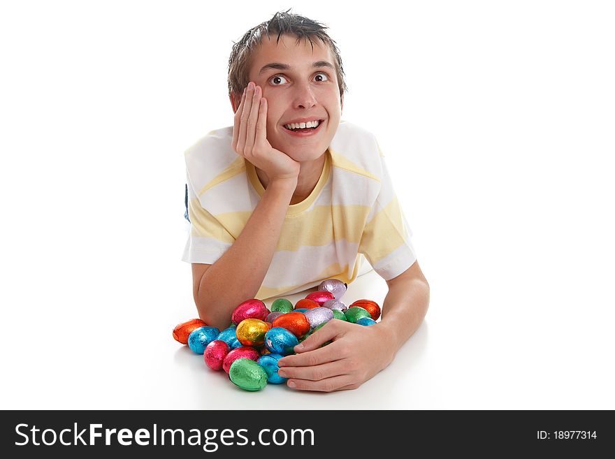 Boy lying down with easter eggs and looking up.  Space for text.  White background. Boy lying down with easter eggs and looking up.  Space for text.  White background.