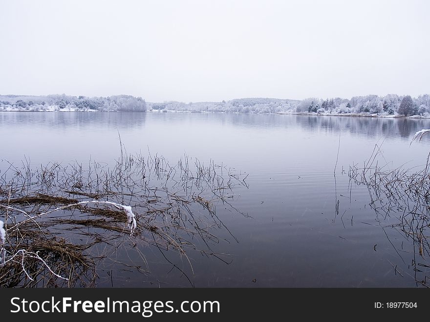 Frozen Thawing Lake In Snow Landscape