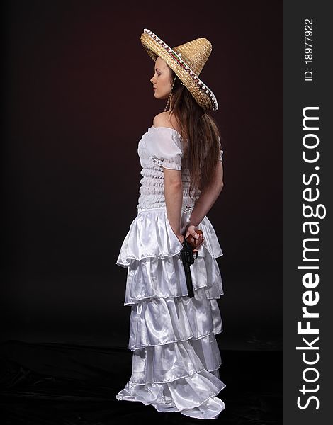 Woman in mexican costume hold revolver. Woman in mexican costume hold revolver