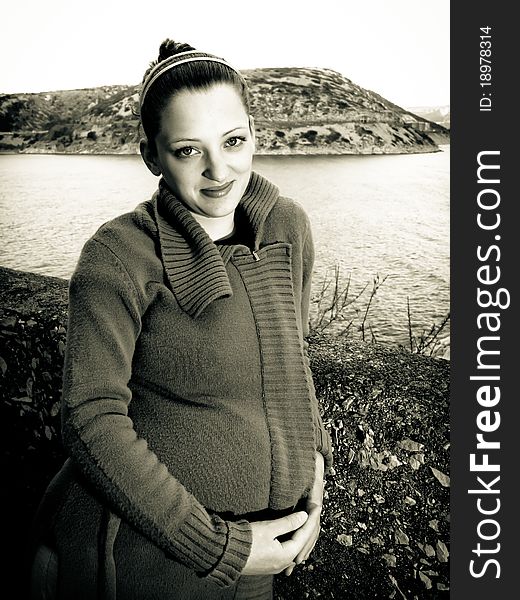 Portrait of beautiful pregnant young woman, pretty eyes and thoughtful look, holding by the wall. Portrait of beautiful pregnant young woman, pretty eyes and thoughtful look, holding by the wall