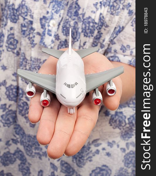 Woman hand with a small toy plane
