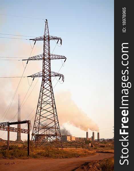 High voltage tower and old steel factory. Smoke. Industria landscape. High voltage tower and old steel factory. Smoke. Industria landscape.