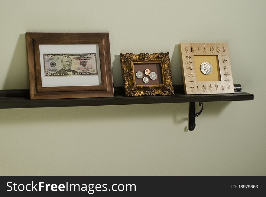 US currency in picture frames on shelf. US currency in picture frames on shelf
