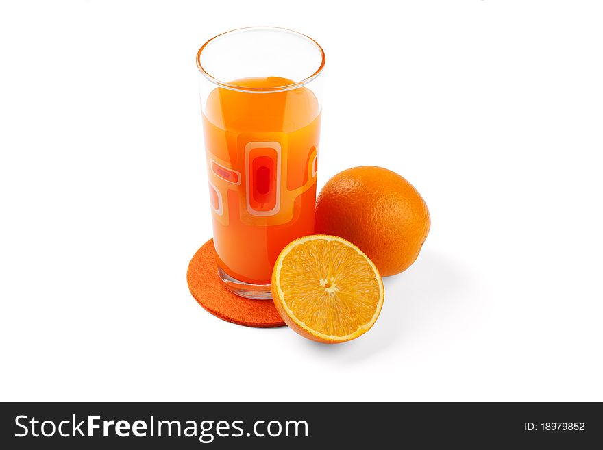 Orange juice in the glass and oranges.
