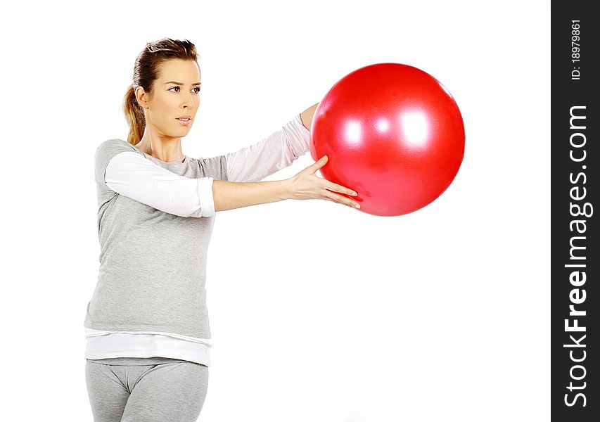 Girl exercising with a red ball, on a white background. Girl exercising with a red ball, on a white background