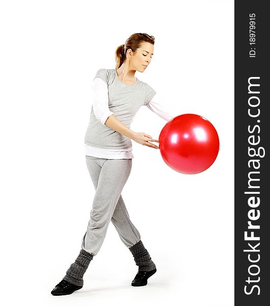 Girl exercising with a red ball, on a white background. Girl exercising with a red ball, on a white background