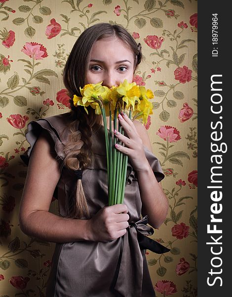 Portrait of the beautiful blond girl with narcissuses. Portrait of the beautiful blond girl with narcissuses
