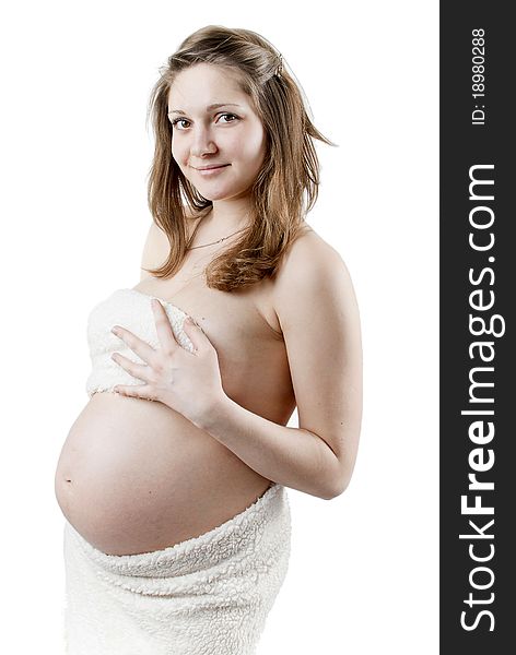 Beautiful pregnant woman in a white fur