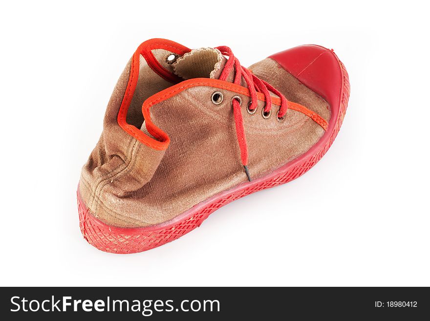 Heavy used old red sport shoes, sneakers (isolated on white background, selective focus)