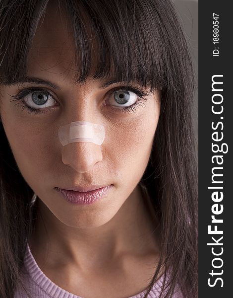 Woman With Bandage On Nose