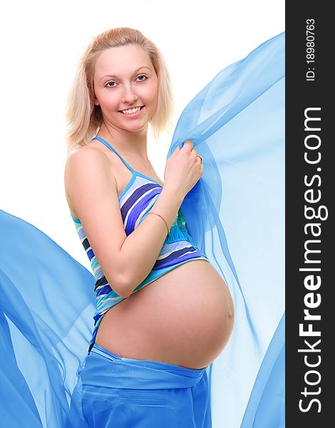 Beautiful young pregnant blonde woman with green transparent cloth in studio. Beautiful young pregnant blonde woman with green transparent cloth in studio