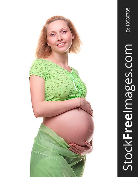 Beautiful young pregnant blonde woman with green transparent cloth in studio. Beautiful young pregnant blonde woman with green transparent cloth in studio