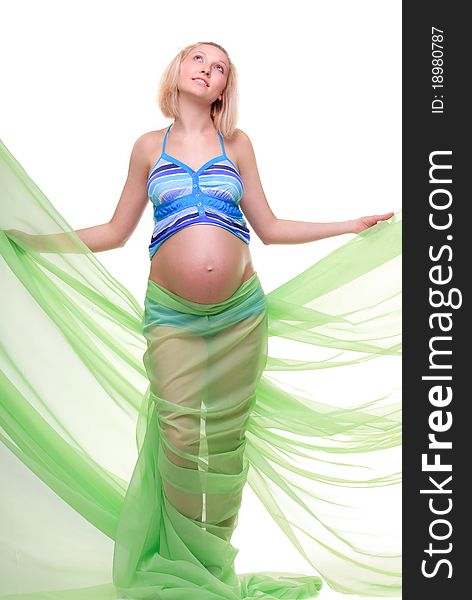Beautiful young pregnant blonde woman with green transparent cloth in studio. Beautiful young pregnant blonde woman with green transparent cloth in studio