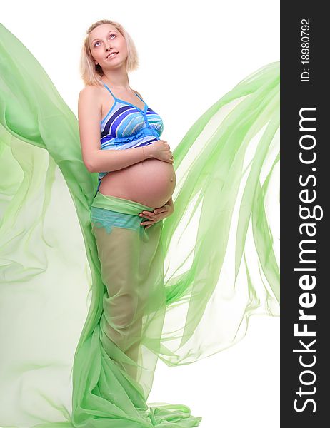 Beautiful young pregnant blonde woman with green transparent cloth in studio. Beautiful young pregnant blonde woman with green transparent cloth in studio