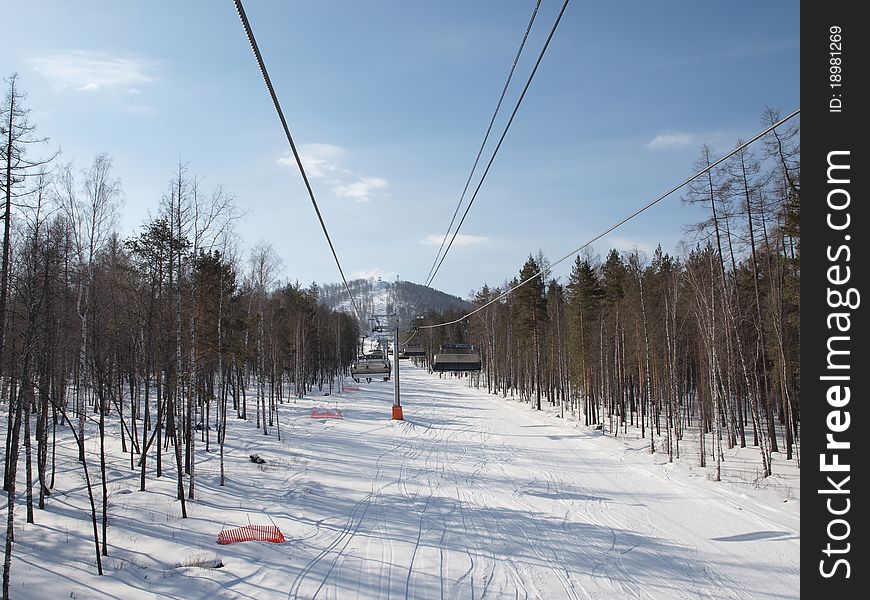 Views of the ski lift on a slope covered with forest. Views of the ski lift on a slope covered with forest