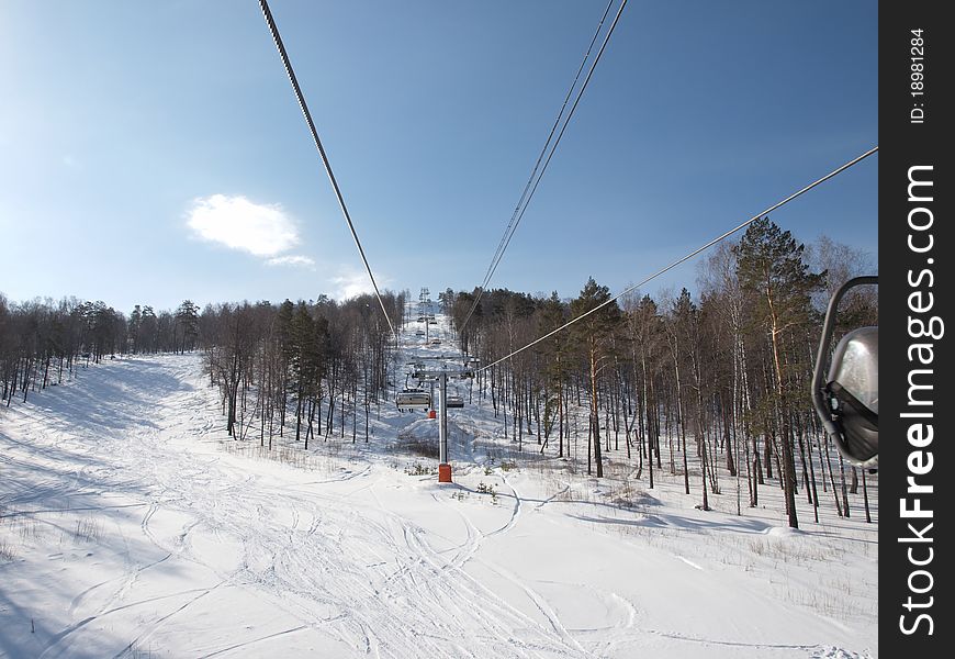 Ski lift on the slope of a forested. Ski lift on the slope of a forested