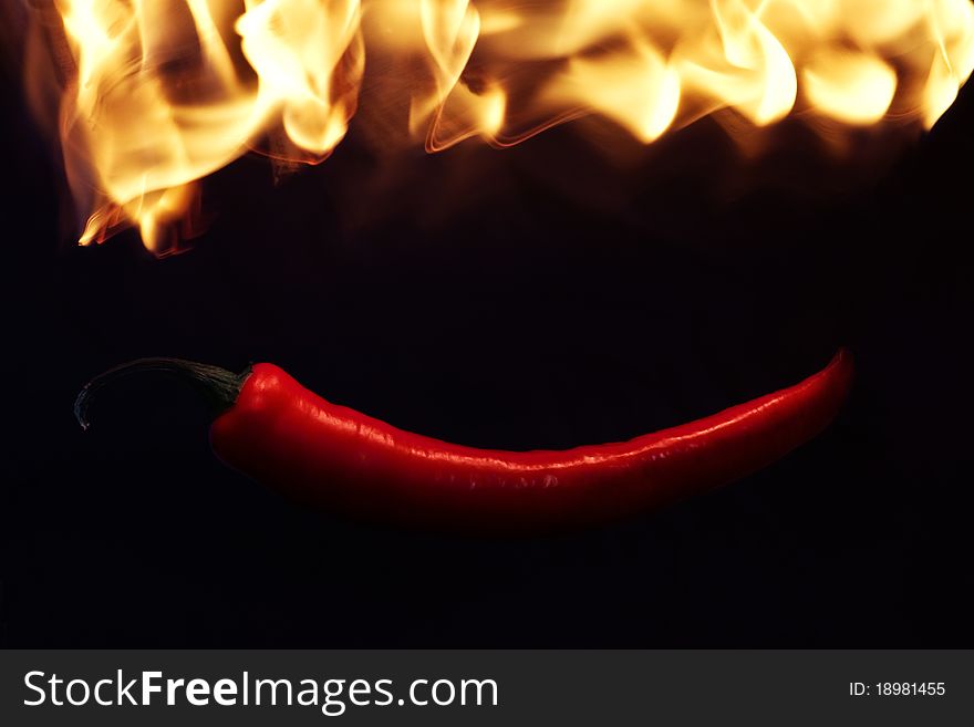 Red pepper in fire flame