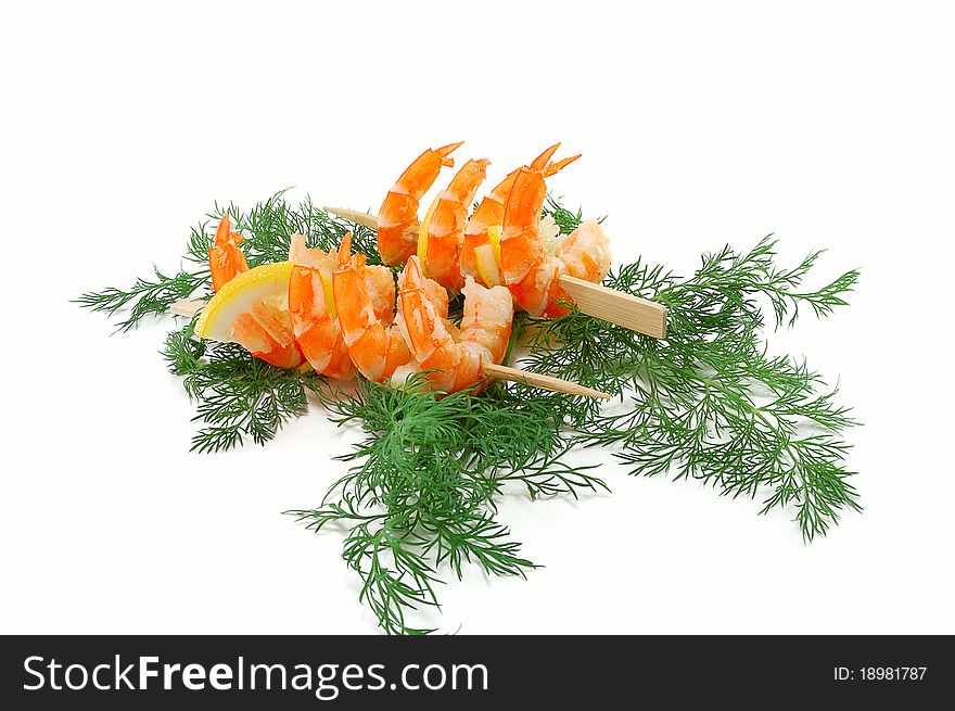 King prawns on bamboo skewers and greens of dill isolated on white background. King prawns on bamboo skewers and greens of dill isolated on white background
