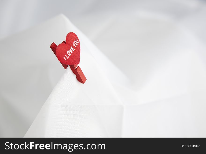 Little heart on a clip in white background