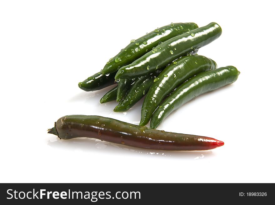 A group of green peppers on a white background
