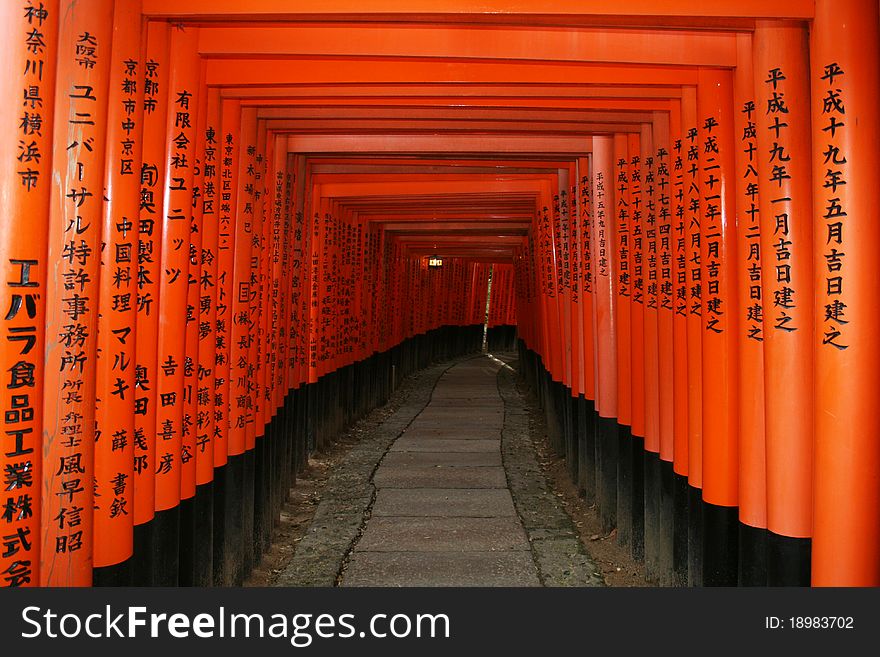 Many shintoist arches (tori) on a hill at inari near kyoto in japan