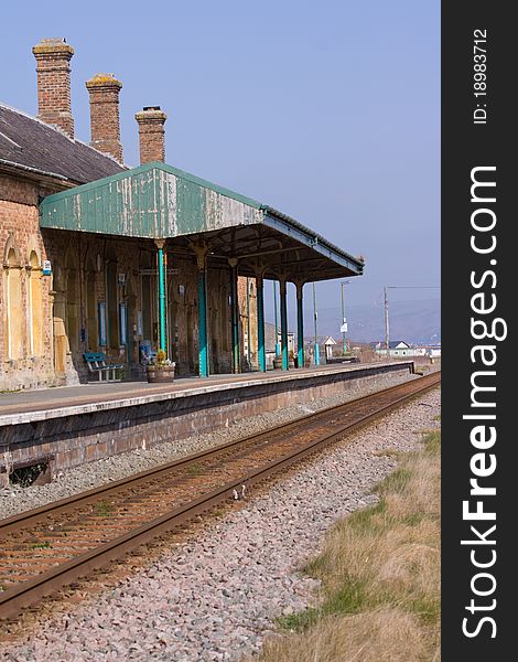 The platform and railway line at a desrted rural railway station. The platform and railway line at a desrted rural railway station