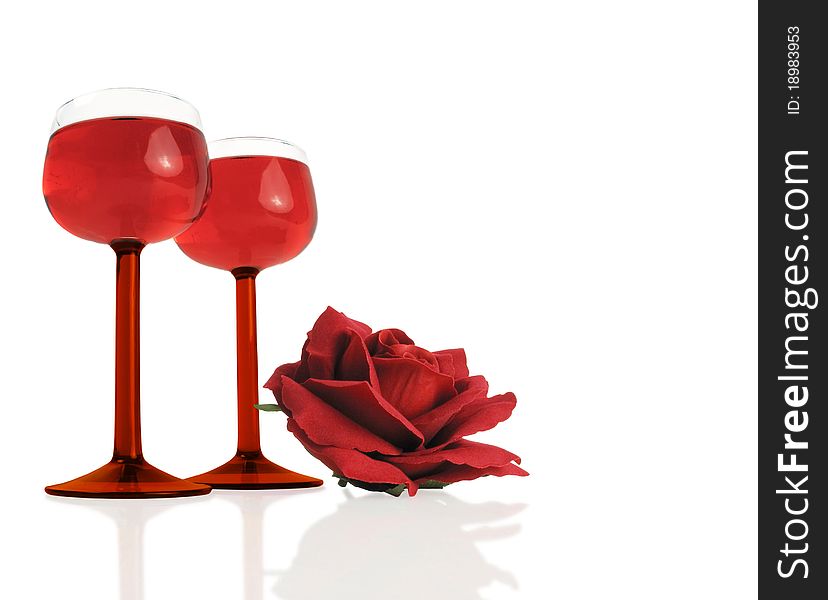 Beautiful wine glasses with a red silk rose on white. Beautiful wine glasses with a red silk rose on white