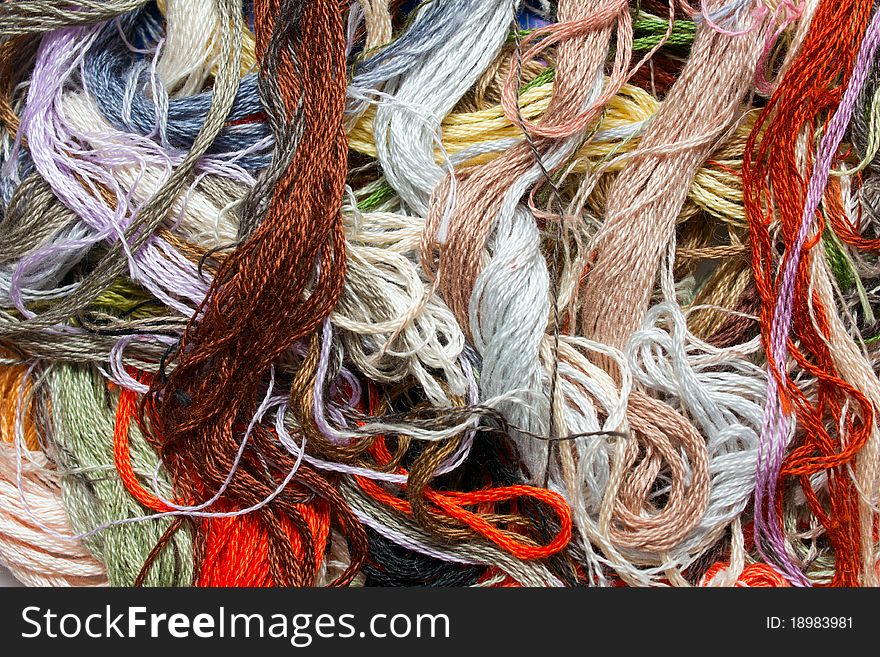 Multicolored cross-stitch threads close up