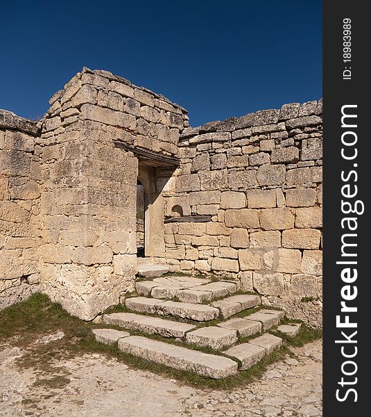 Steps and door to the ancient stone wall