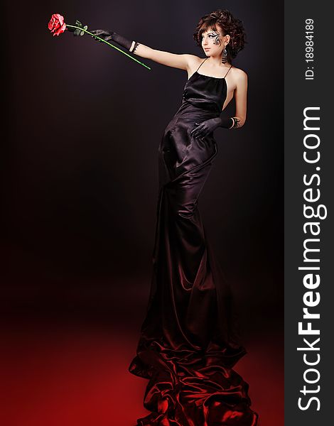 Beautiful fashionable woman in black dress. Studio shot. Beautiful fashionable woman in black dress. Studio shot.