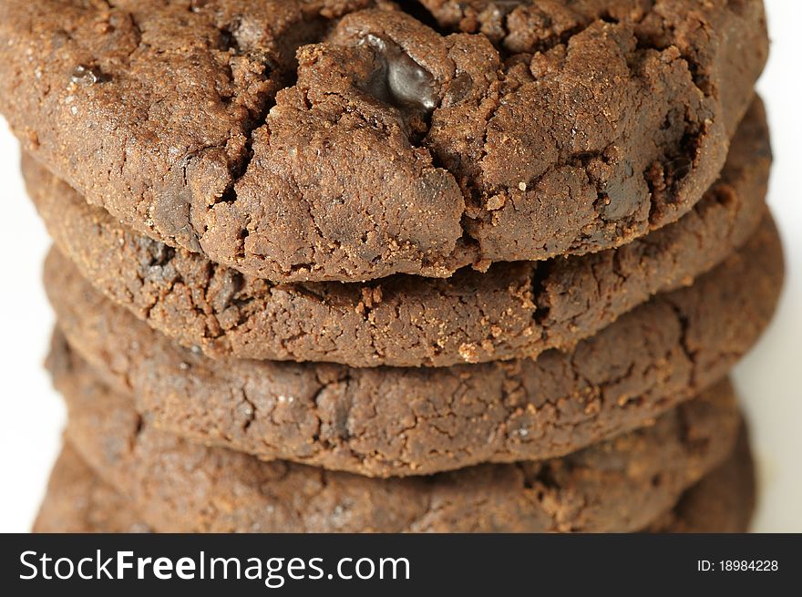 Stack of chocolate cookies on white background