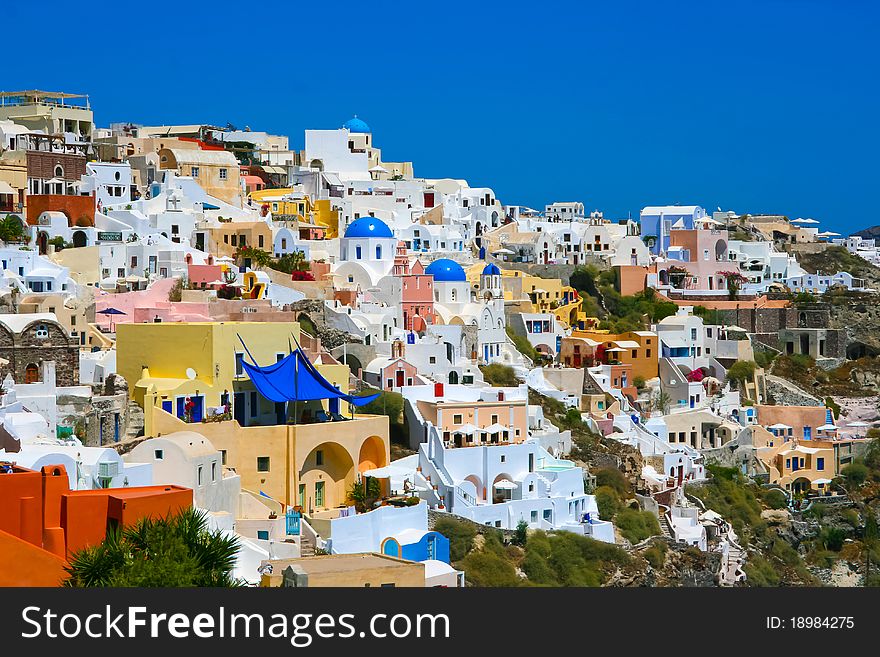 Classic view of Oia on island of Santorini in Greece. Traditional architecture with famous blue belfries. Classic view of Oia on island of Santorini in Greece. Traditional architecture with famous blue belfries.