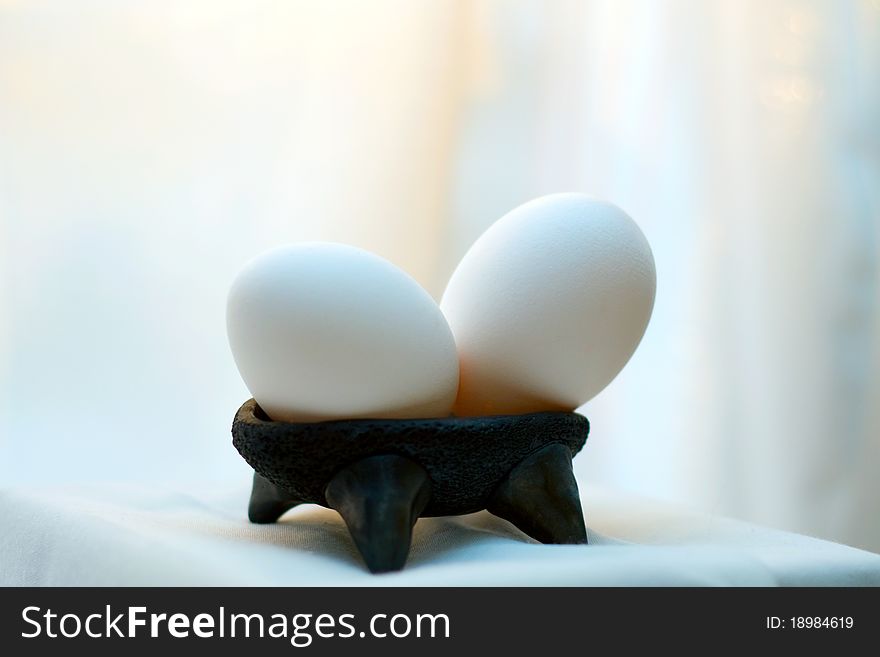 White natural easter egg in small black dish. White natural easter egg in small black dish